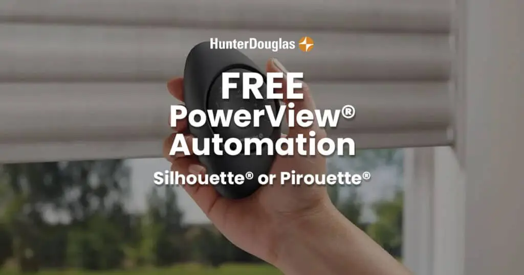 Close-up of a hand holding a black sphere with HunterDouglas PowerView Automation logo, outdoor background with blinds and trees.