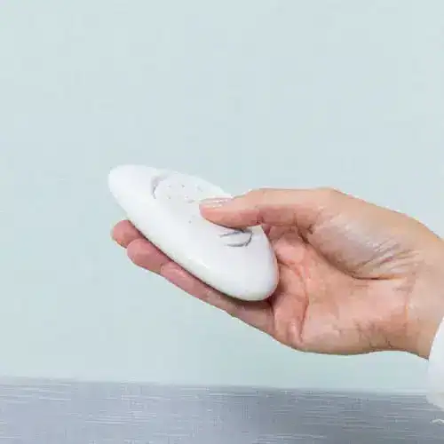 Soft white remote control for window blinds or shades, ideal for modern home automation and convenience.