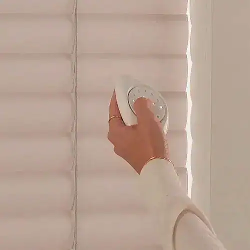 White window blinds adjustment with remote control, effortlessly operating home window coverings, easy-to-use blinds control by Blinds West.