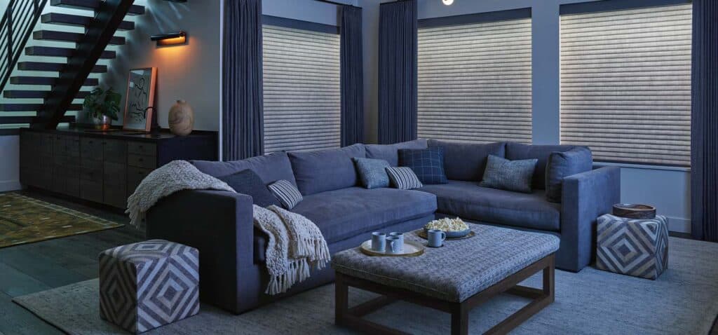 Luxurious living room with custom window blinds, navy curtains, and modern decor, showcasing premium window treatment solutions from Blinds West.