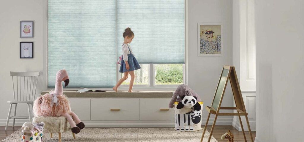 Luxurious light blue window blinds in a children's room with playful stuffed animals and cute decor, providing style and functionality with custom window treatment options from Blinds West.