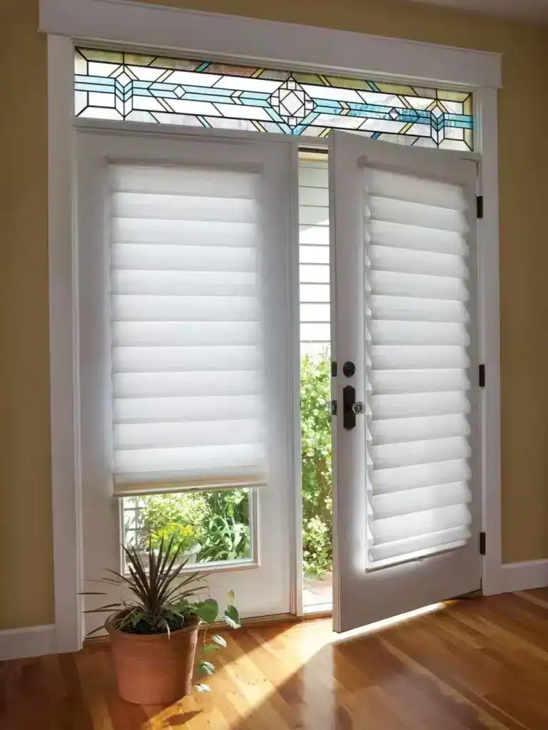 White window blinds with fabric coverings and decorative stained glass transom window, offering privacy and style for home decor.