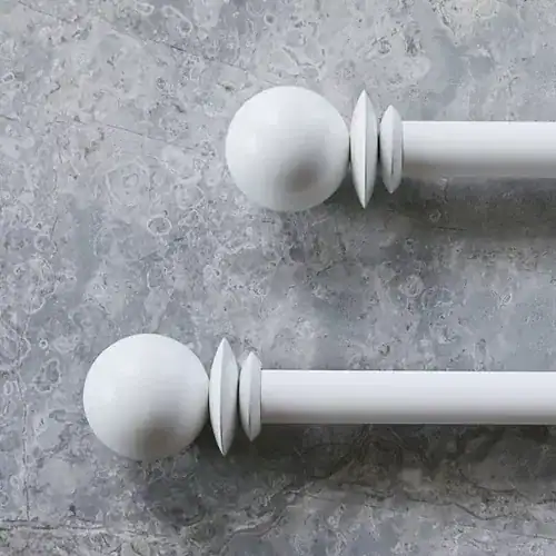 Elegant white curtain rod with spherical finials ideal for home window treatments and drapery systems. Perfect for enhancing your interior decor with custom blinds and window treatments.