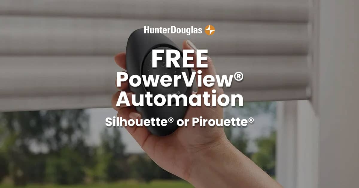 Close-up of a hand holding a black sphere with HunterDouglas PowerView Automation logo, outdoor background with blinds and trees.